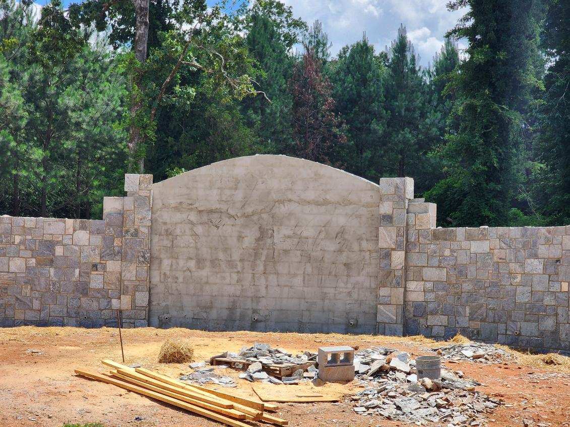 Stone wall under construction with materials