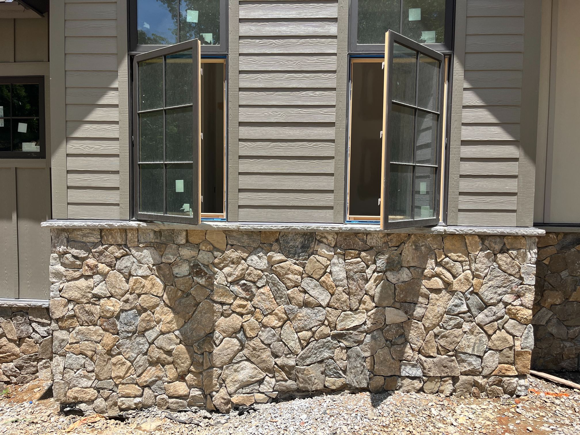 Open windows on stone-clad wall