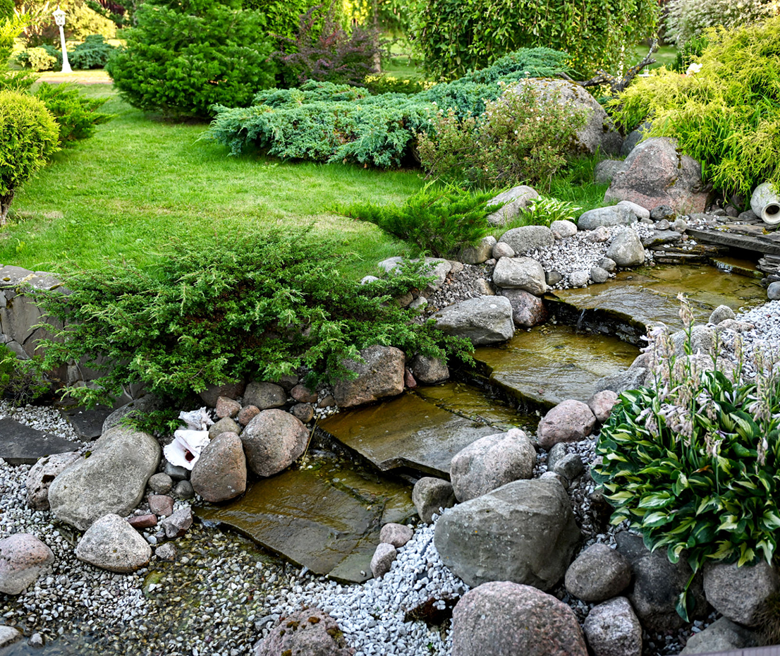 Lush garden landscape with small creek