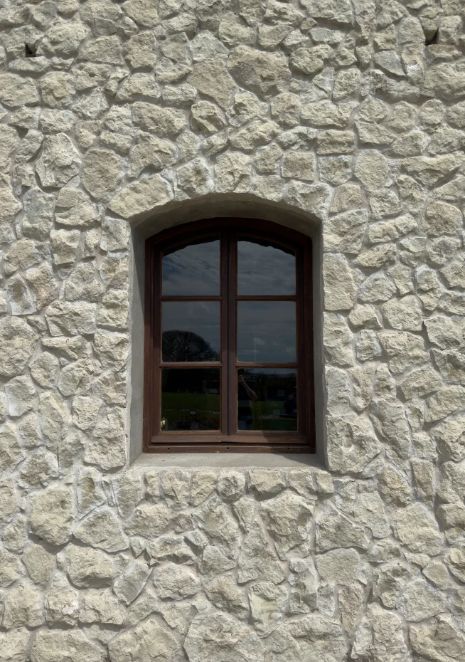 Arched window in stone wall