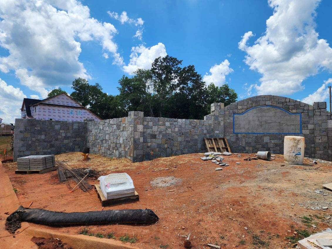 Building foundation with stone wall and materials